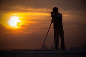 photographer on the roof makes the sunset photo