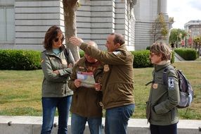 a group of people are looking at a map