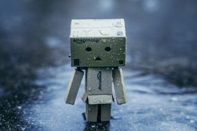 cardboard figure in the rain