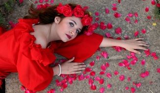 model in red dress and roses wreath