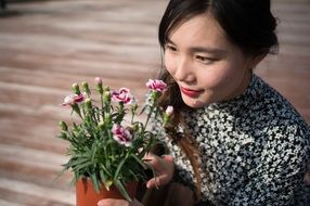 asian lady with potted flowers