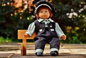 doll in a suit on the bench in the park