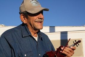 Old musician playing violin