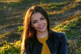 portrait of a smiling girl in a leather jacket