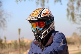 Bikerâs head in colorful painted Helmet