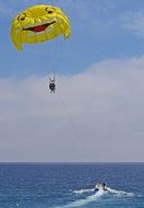yellow funny parachute over the sea