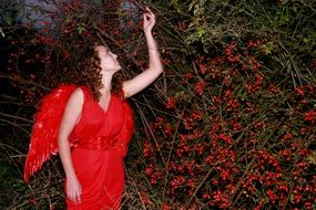 girl angel among red berries