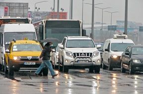 car stopped in front of the pedestrian crossing