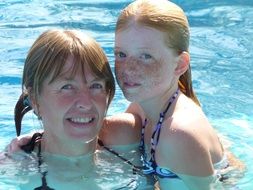 mother with daughter in the pool