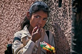 Indian student with food on a city street