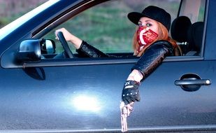 model with a gun in the car