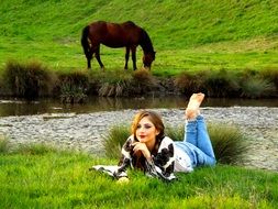 beautiful girl and horse near the water