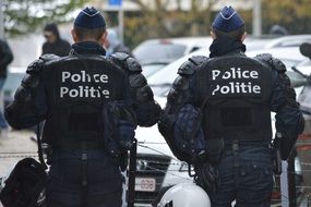 two police officers in uniform on a city street