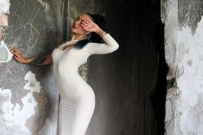 girl in a white tight dress among the ruins