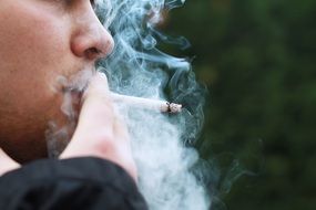man smokes a cigarette
