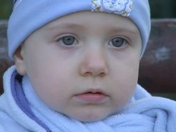 portrait of a boy in a blue cap