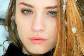 winter portrait of a blonde with green eyes