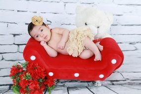 newborn on the red couch