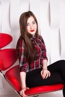 girl sitting on a red chair