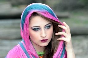 thoughtful woman with head covered with scarf