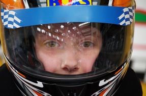 photo of a boy in a racing helmet