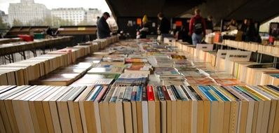 unrecognizable people picking Books on Market, uk, London