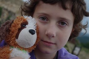 boy's face with a toy dog