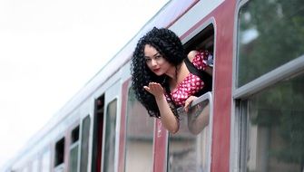 beautiful brunette in the window of a train