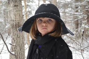 picture of the girl is in a snowy forest
