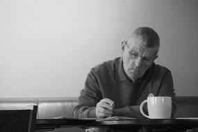 Black and white photo of the Man drinking coffee