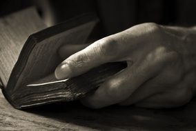 hands on old book close up