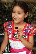 mexican girl in national costume with microphone