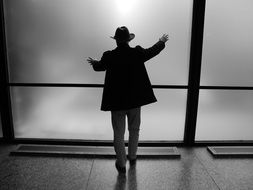 Black and white photo of the Silhouette of a man in hat