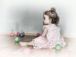 cute curly girl on the floor with balls