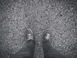 Man’s Feet in Sneakers on Concrete