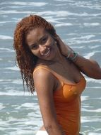 girl in orange bathing suit in the sea