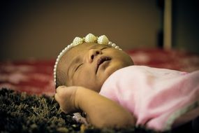 Newborn asian Baby girl lays on her back