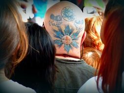the blue tattoo on his bald head