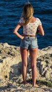 Girl on the rocks in summer