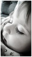 black white photo of cute little baby asleep