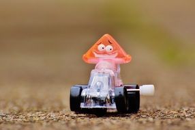 toy in the form of a red triangle on a racing car