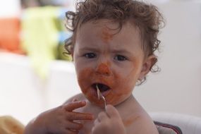 funny boy eats tomato mass