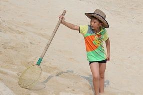 young fisherman with a net on the beach