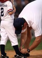 young baseball player with the coach