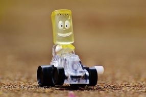 closeup picture of toy in the form of a yellow square on a racing car