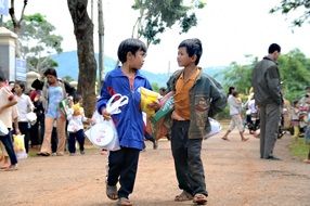 Vietnamese children with presents in the street