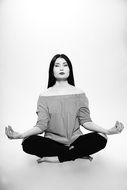 black and white photo of a woman in yoga pose