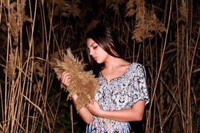 girl among high reeds at dusk