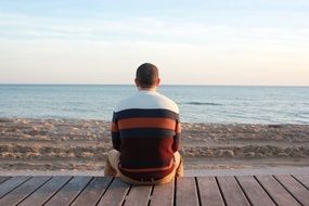 photo of the lonely man is on a beach