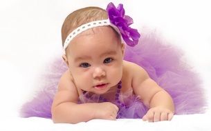 little girl with a purple bow on her head